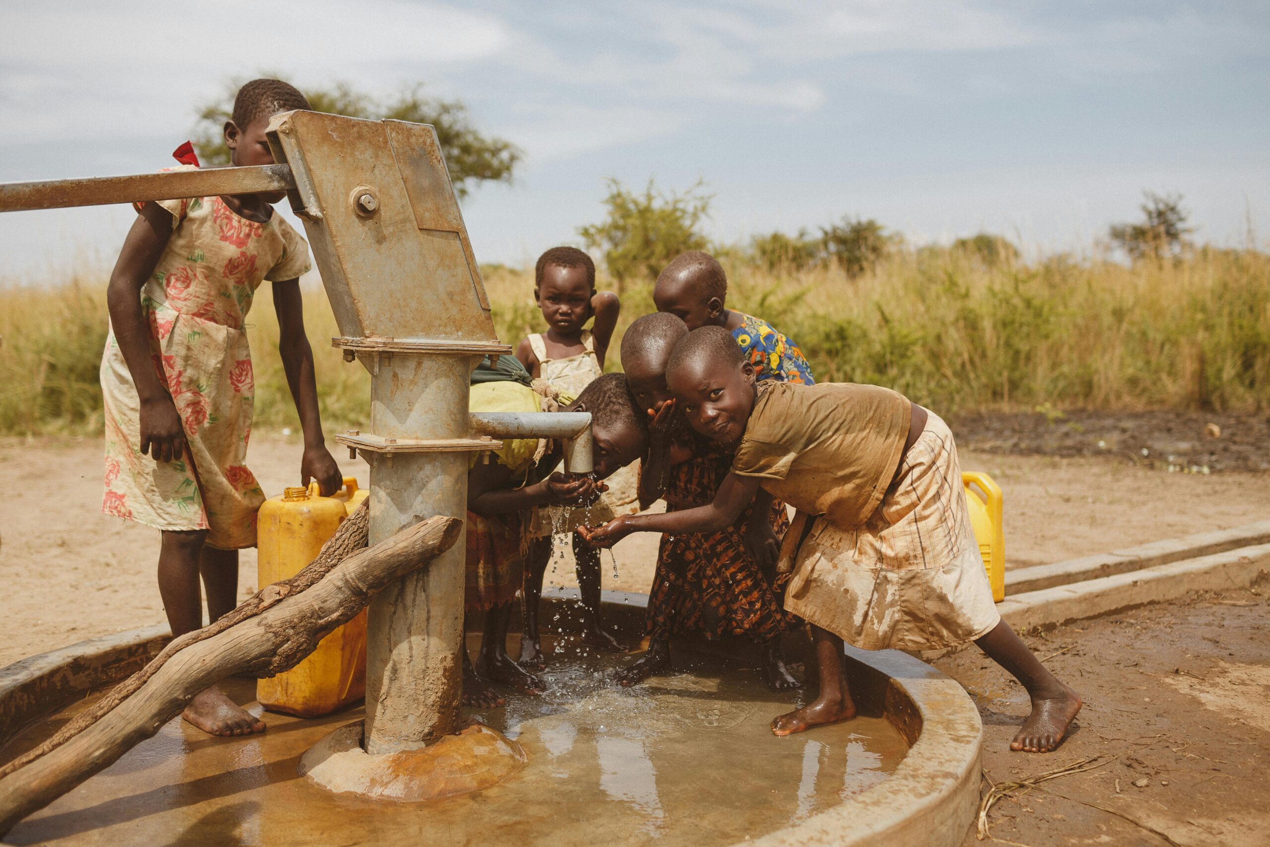 Group of children gathering water from a well in Kitgum, Uganda.